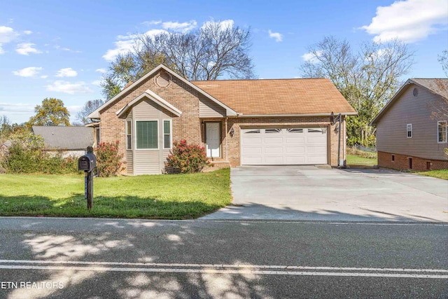 view of front of property featuring a front yard and a garage