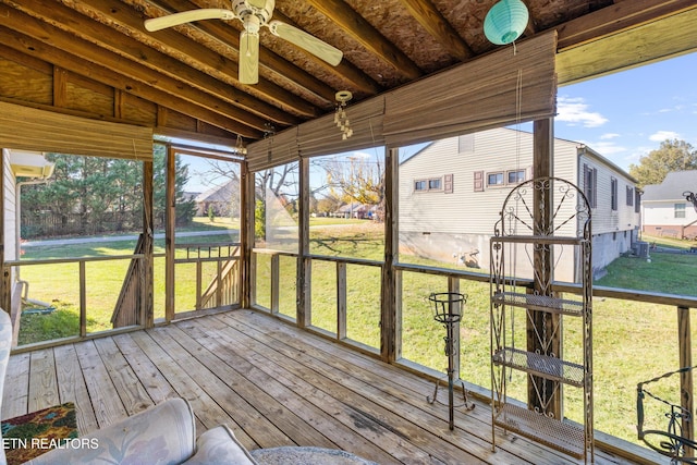 unfurnished sunroom with ceiling fan