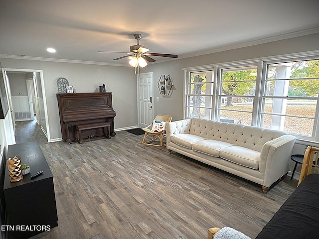 living room with hardwood / wood-style floors, ceiling fan, and crown molding