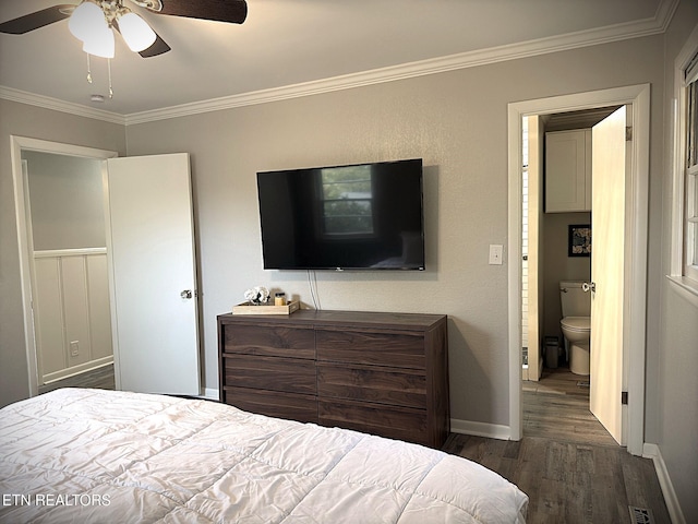 bedroom featuring dark hardwood / wood-style floors, ceiling fan, ornamental molding, and ensuite bathroom