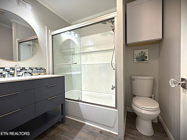 full bathroom with vanity, hardwood / wood-style flooring, toilet, enclosed tub / shower combo, and ornamental molding