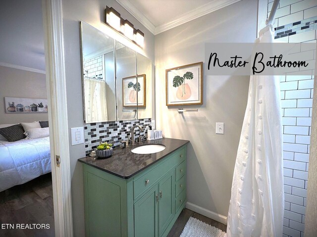 bathroom with decorative backsplash, wood-type flooring, vanity, and ornamental molding