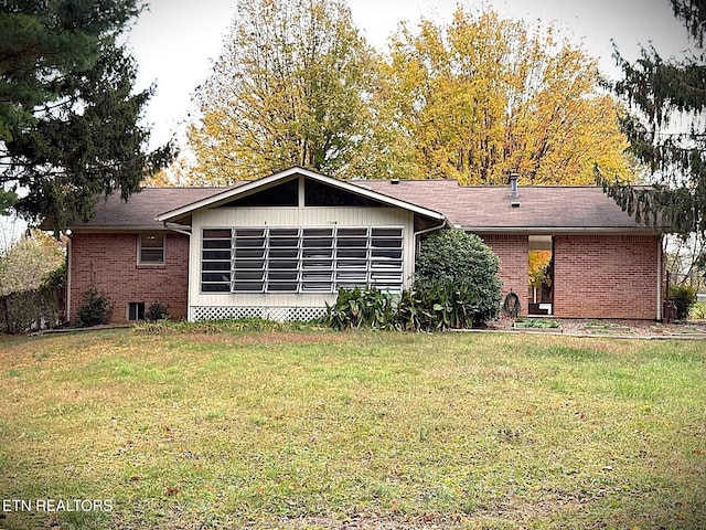 back of house with a yard