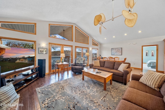 living room featuring hardwood / wood-style floors, ceiling fan, a textured ceiling, and high vaulted ceiling