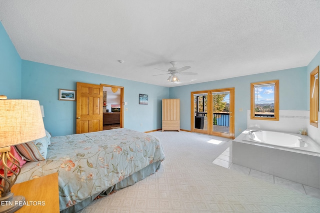 bedroom with ceiling fan, access to exterior, a textured ceiling, and light colored carpet