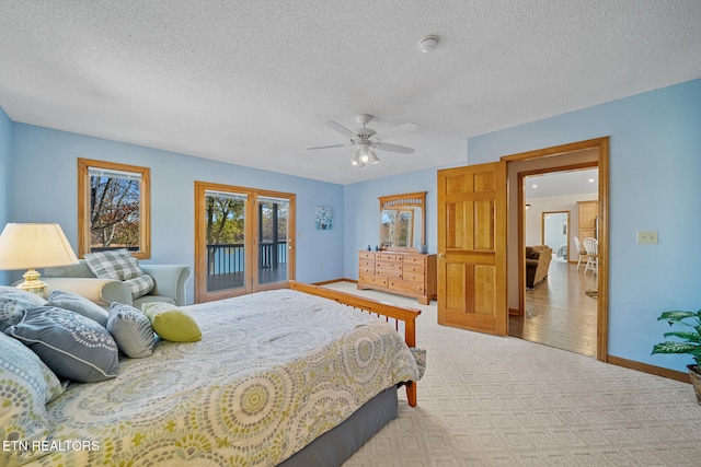 carpeted bedroom with a textured ceiling, ceiling fan, and access to exterior