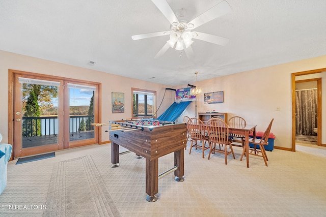 recreation room featuring ceiling fan, a wealth of natural light, and light colored carpet