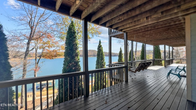 wooden deck featuring a water view