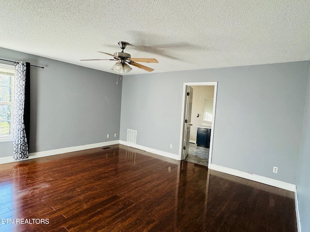 spare room with a textured ceiling, hardwood / wood-style flooring, and ceiling fan