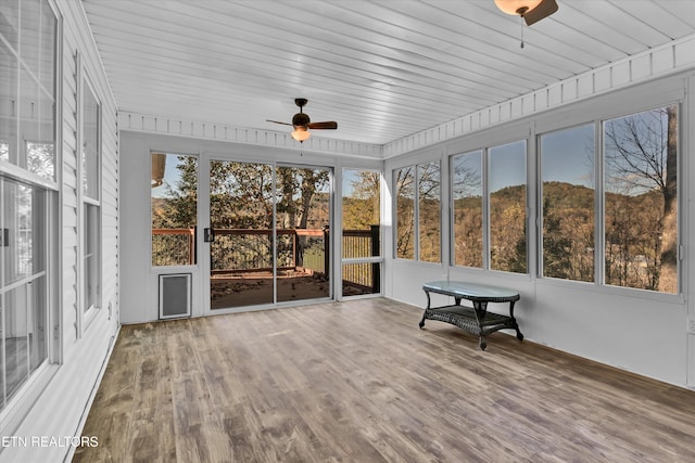 sunroom featuring ceiling fan and wooden ceiling