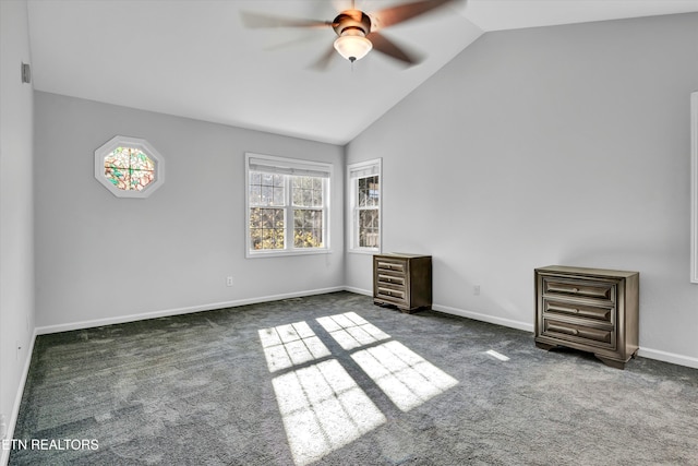 unfurnished bedroom featuring dark colored carpet, ceiling fan, and vaulted ceiling