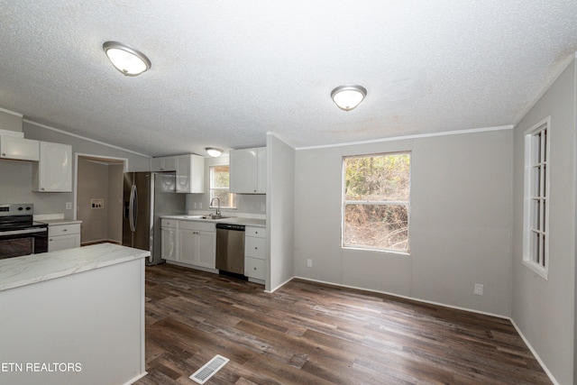 kitchen featuring sink, dark hardwood / wood-style floors, a textured ceiling, white cabinets, and appliances with stainless steel finishes