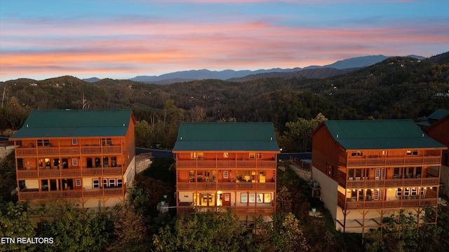 aerial view at dusk featuring a mountain view