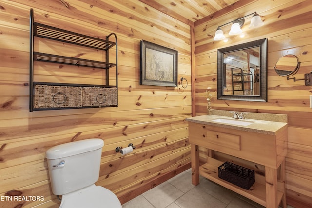 bathroom featuring wood walls and tile patterned flooring