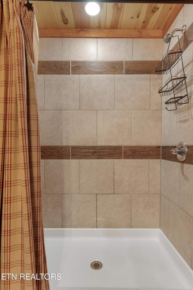 bathroom featuring a shower with curtain and wood ceiling