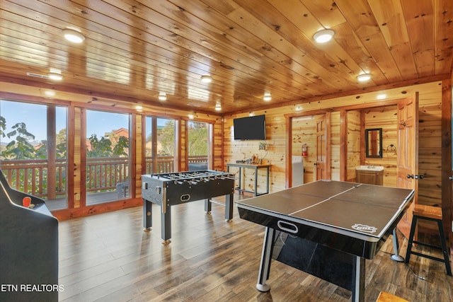 recreation room featuring wooden walls, wood ceiling, hardwood / wood-style flooring, and plenty of natural light