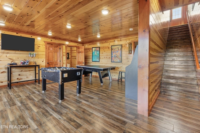 game room with dark wood-type flooring, wooden walls, and wood ceiling