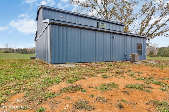 view of home's exterior featuring an outdoor structure and central AC