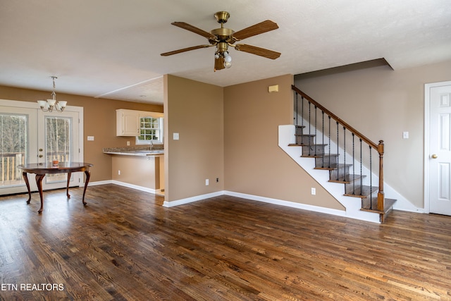 living room with french doors, dark hardwood / wood-style floors, and ceiling fan with notable chandelier