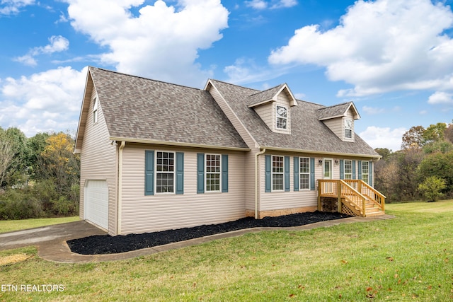 cape cod house featuring a front lawn and a garage