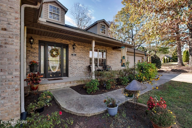 doorway to property with a porch and a garage