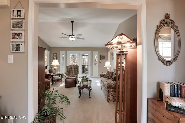 living room with french doors, light colored carpet, ceiling fan, and lofted ceiling