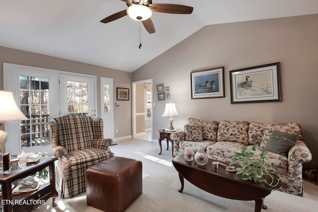 living room featuring ceiling fan, light carpet, and vaulted ceiling