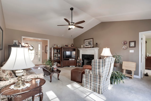 carpeted living room featuring vaulted ceiling and ceiling fan