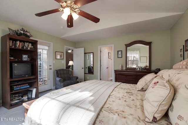 carpeted bedroom with ceiling fan and vaulted ceiling