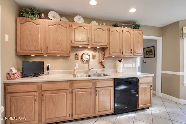 kitchen with light brown cabinets, sink, light tile patterned floors, and black dishwasher