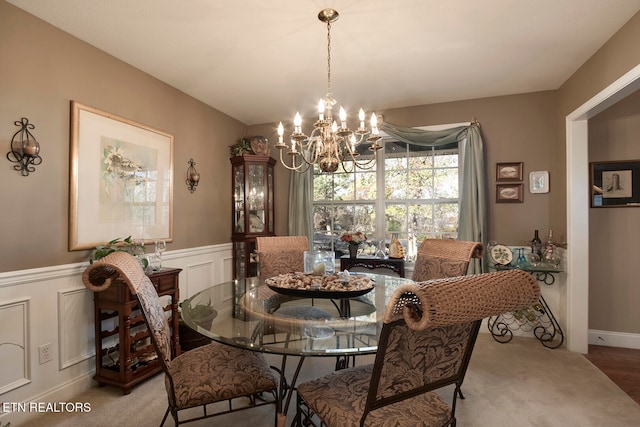 dining room featuring carpet floors and an inviting chandelier