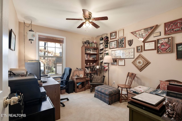 home office featuring light colored carpet and ceiling fan