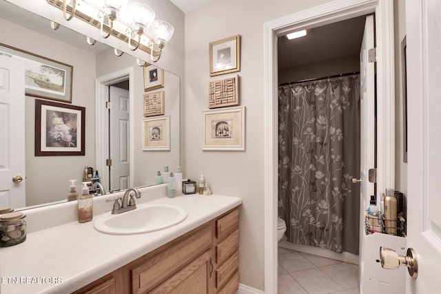 bathroom with tile patterned flooring, vanity, and toilet