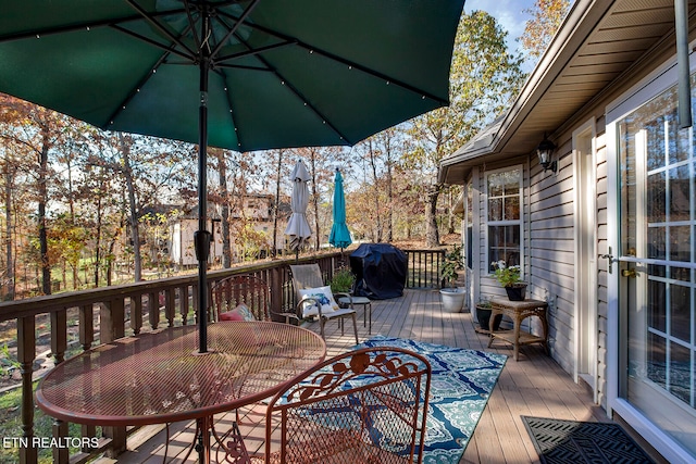 wooden terrace with a grill