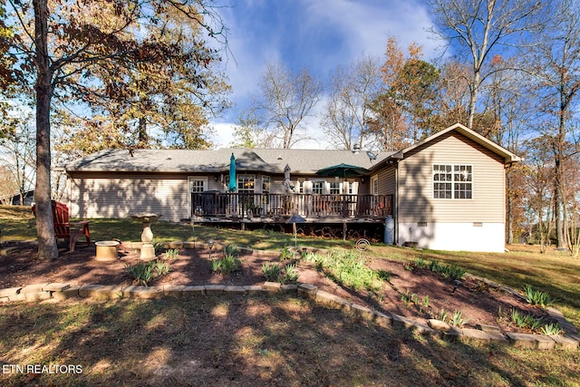 rear view of house featuring a yard and a wooden deck