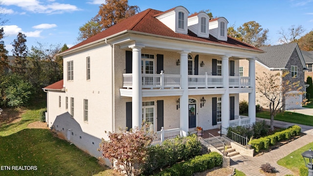 view of front of house with a porch and a balcony