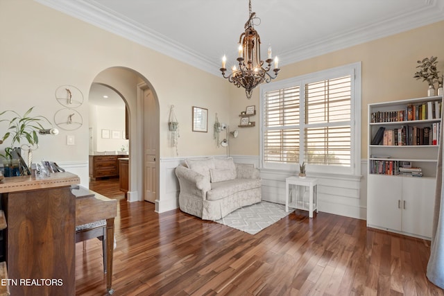 sitting room with a chandelier, hardwood / wood-style floors, and crown molding