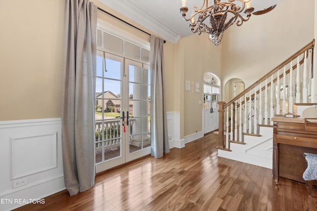 foyer featuring french doors, a notable chandelier, and hardwood / wood-style flooring