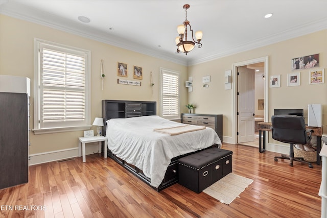 bedroom featuring a notable chandelier, hardwood / wood-style flooring, and crown molding