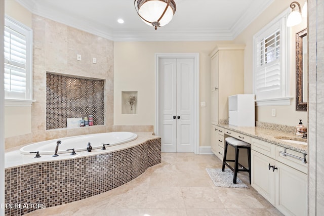 bathroom featuring tiled tub, crown molding, and vanity