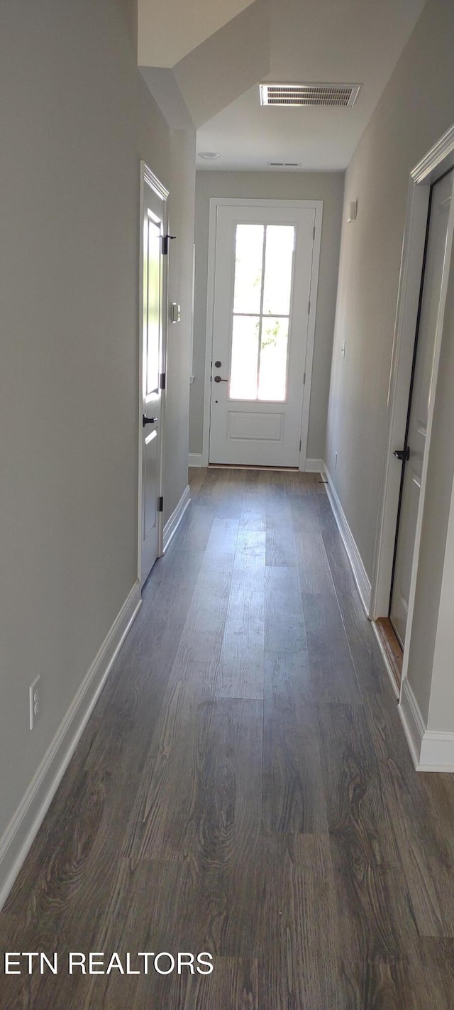 entryway with dark hardwood / wood-style flooring