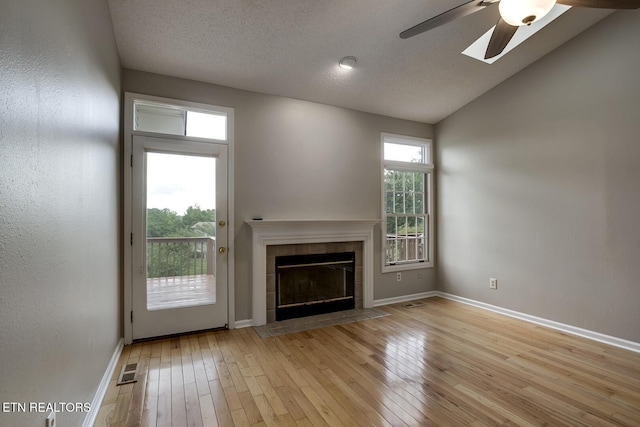 105 Poteau Trce, Loudon, TN 37774 - unfurnished living room featuring a fireplace, ceiling fan, hardwood / wood-style flooring, baseboards, and lofted ceiling