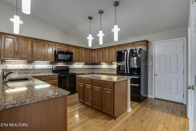105 Poteau Trce, Loudon, TN 37774 - kitchen with black appliances, a sink, stone countertops, decorative backsplash, and vaulted ceiling