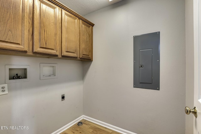 105 Poteau Trce, Loudon, TN 37774 - washroom featuring electric panel, cabinet space, hookup for an electric dryer, washer hookup, and light wood-type flooring