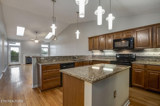 105 Poteau Trce, Loudon, TN 37774 - kitchen featuring black appliances, a sink, a peninsula, a skylight, and light wood-style flooring