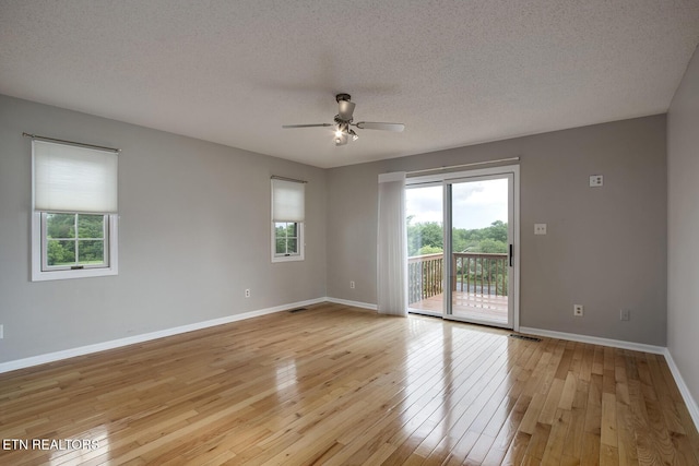 105 Poteau Trce, Loudon, TN 37774 - unfurnished room featuring healthy amount of natural light, light wood-style flooring, a ceiling fan, baseboards, and a textured ceiling