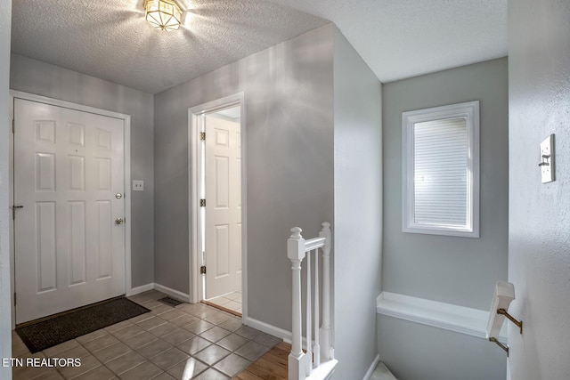 105 Poteau Trce, Loudon, TN 37774 - foyer featuring a textured ceiling, tile patterned floors, and baseboards