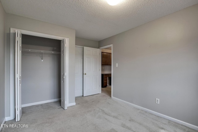 105 Poteau Trce, Loudon, TN 37774 - unfurnished bedroom featuring light colored carpet, a closet, baseboards, and a textured ceiling