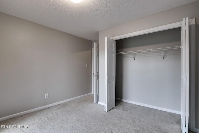 105 Poteau Trce, Loudon, TN 37774 - unfurnished bedroom featuring carpet floors, baseboards, a closet, and a textured ceiling
