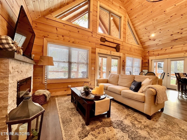 living room with french doors, plenty of natural light, and high vaulted ceiling